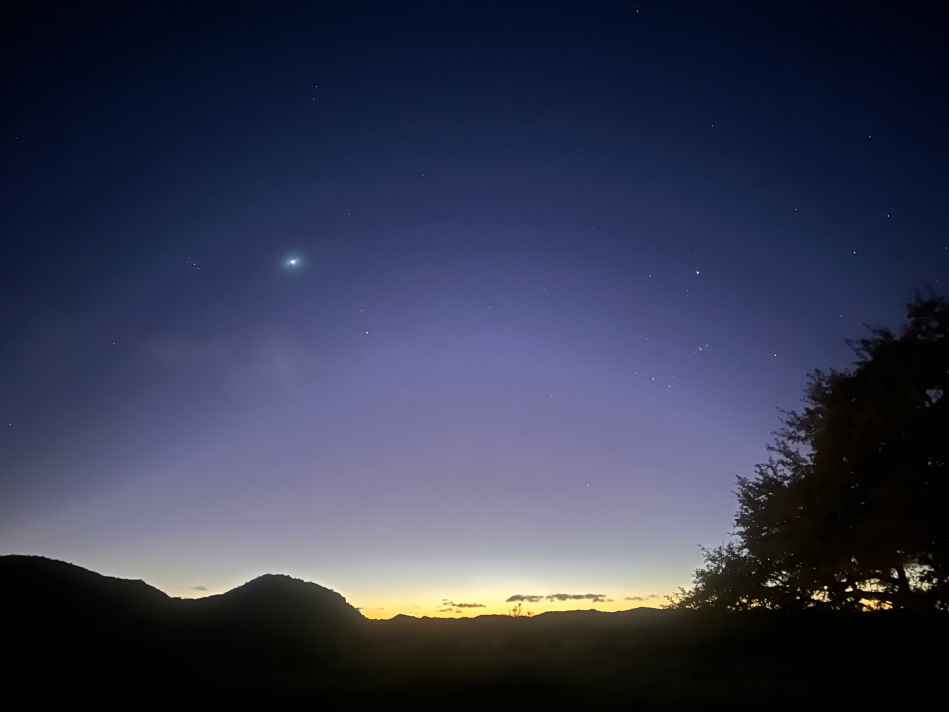Stars over a mountain ridge before dawn